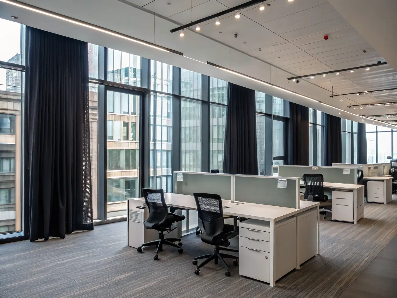 A brightly lit modern office space with visible electrical wiring and fixtures, symbolizing new commercial electrical installations.